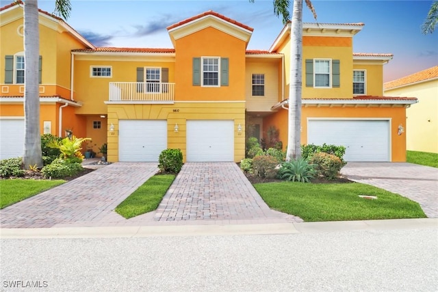 townhome / multi-family property featuring a garage and a balcony