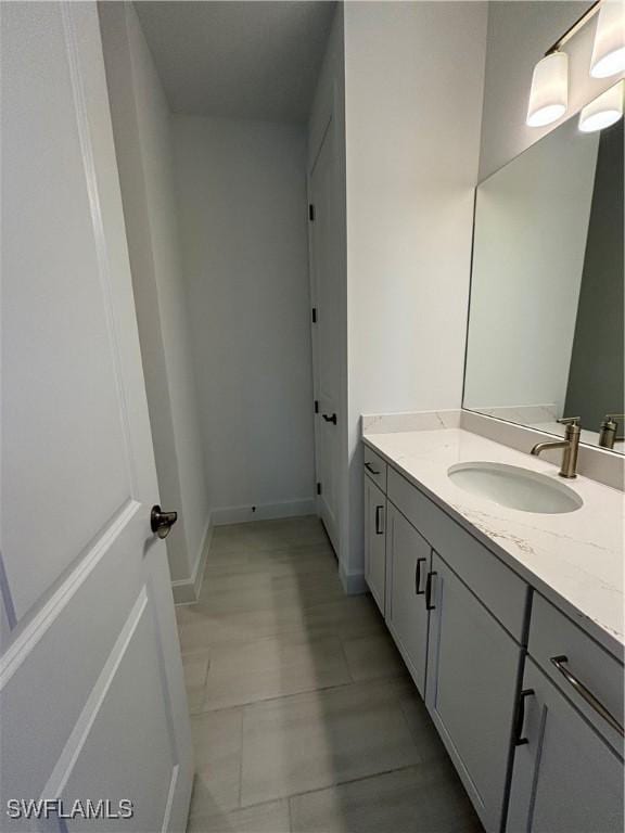 bathroom with baseboards and vanity