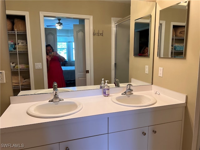 bathroom with ceiling fan and double vanity