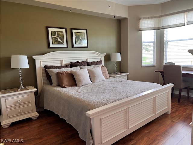 bedroom with dark wood-type flooring