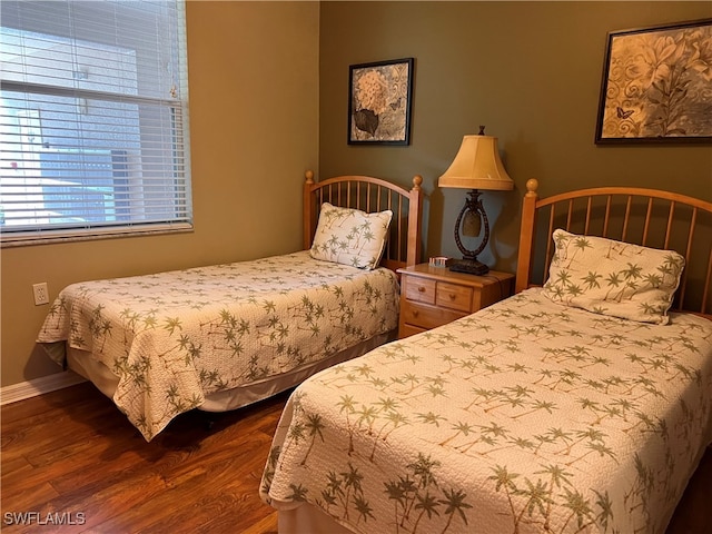 bedroom with dark wood-type flooring