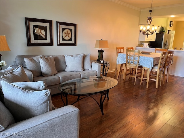 living room with dark hardwood / wood-style floors, an inviting chandelier, and crown molding