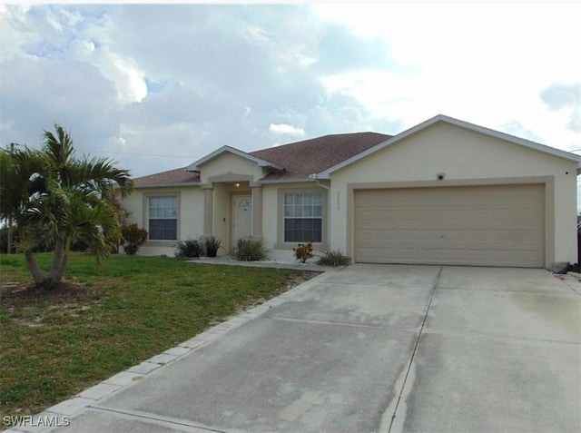 ranch-style house featuring a garage and a front lawn