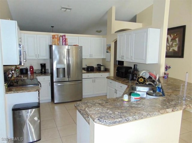 kitchen with white cabinets, stainless steel fridge with ice dispenser, and kitchen peninsula