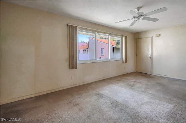 carpeted empty room featuring ceiling fan