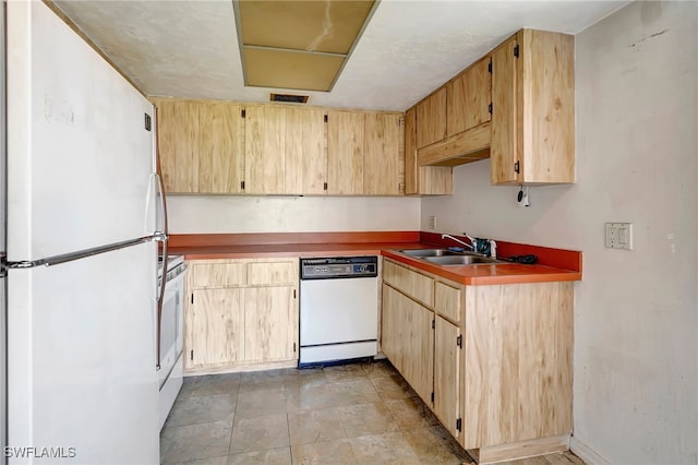 kitchen featuring sink, white appliances, and light tile patterned floors