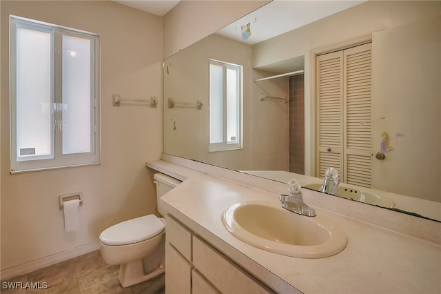 bathroom featuring toilet, vanity, and tile patterned floors