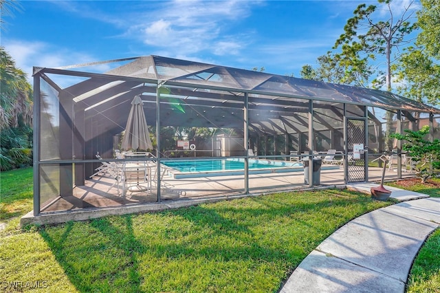 view of swimming pool with a lawn, glass enclosure, and a patio