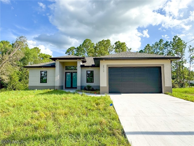 view of front of property featuring a front yard and a garage