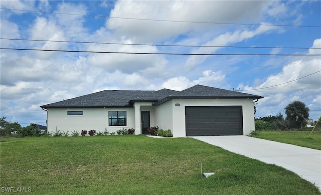 view of front of property with a garage and a front lawn