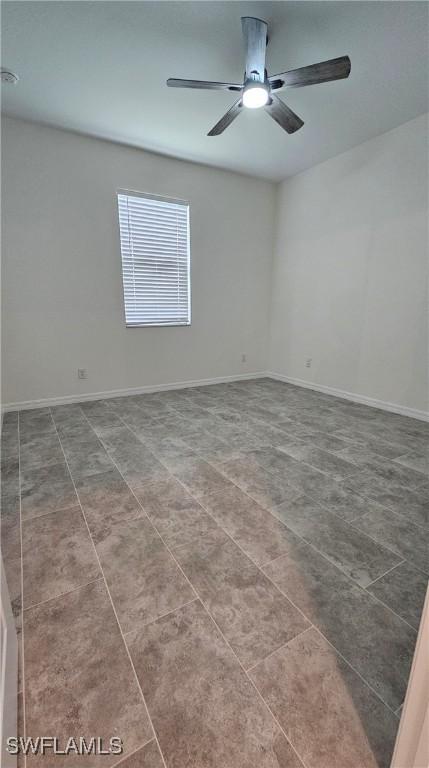 unfurnished room featuring tile patterned flooring and ceiling fan