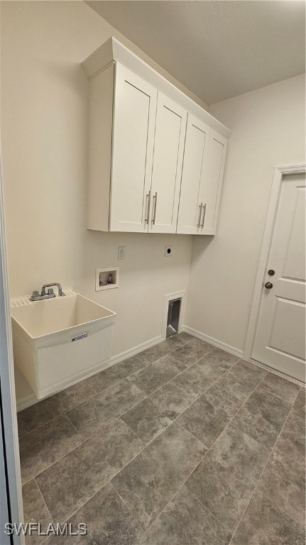 laundry area featuring hookup for a washing machine, dark tile patterned flooring, sink, cabinets, and hookup for an electric dryer