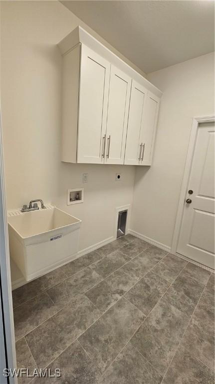 clothes washing area featuring cabinets, electric dryer hookup, sink, and washer hookup