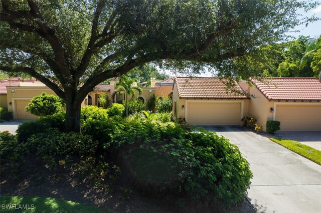 mediterranean / spanish-style house with a garage