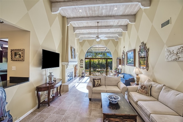 living room with ceiling fan, light tile patterned floors, high vaulted ceiling, and beamed ceiling