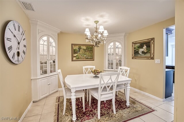 tiled dining space featuring a chandelier