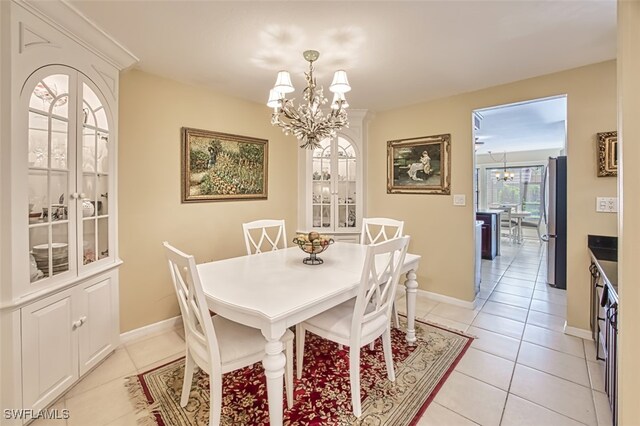 tiled dining area with an inviting chandelier