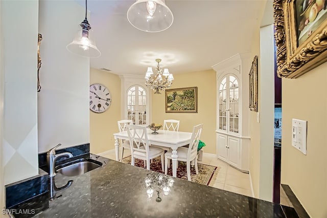 dining space with a healthy amount of sunlight, sink, a chandelier, and light tile patterned flooring