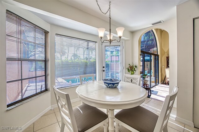 tiled dining area with a notable chandelier