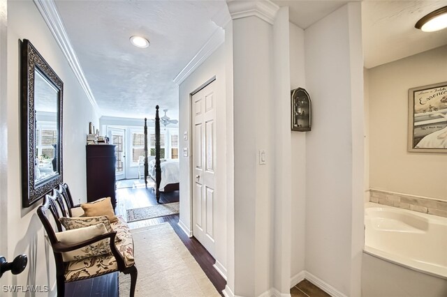 hall featuring crown molding and dark hardwood / wood-style floors