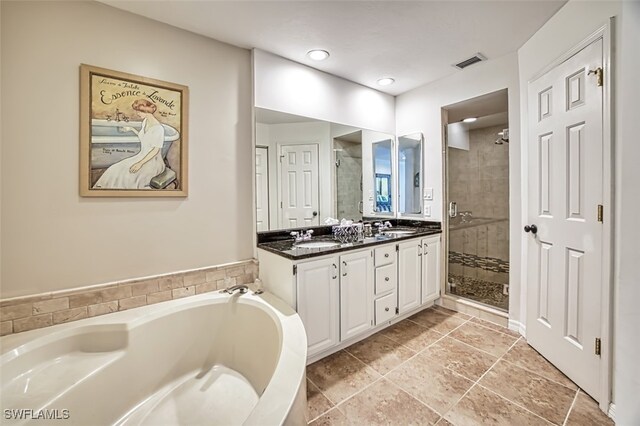 bathroom with shower with separate bathtub and vanity