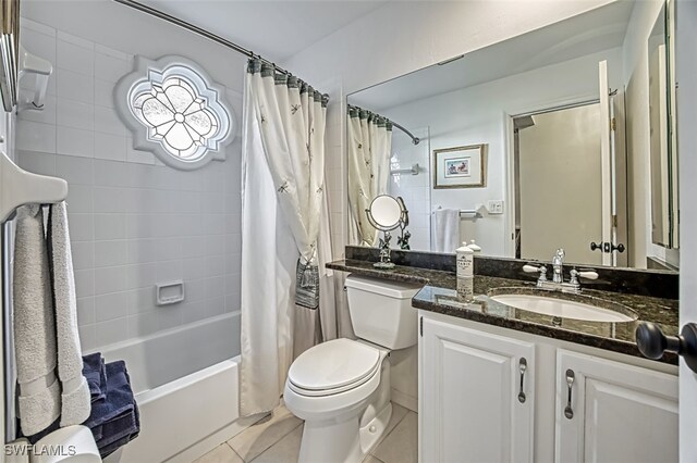 full bathroom with tile patterned flooring, vanity, shower / bath combination with curtain, and toilet