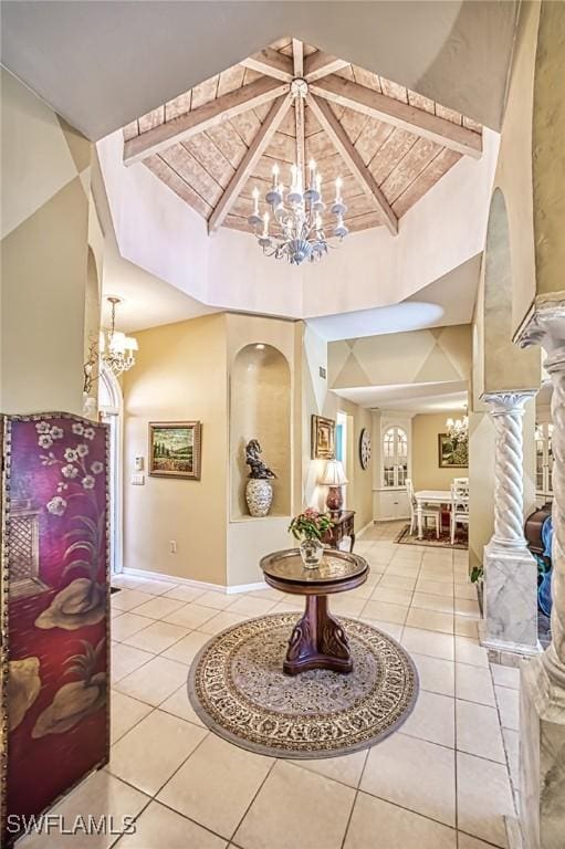 tiled entryway with vaulted ceiling with beams and an inviting chandelier