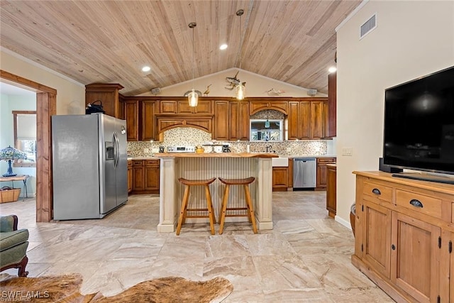 kitchen with backsplash, hanging light fixtures, a breakfast bar, light tile patterned flooring, and stainless steel appliances