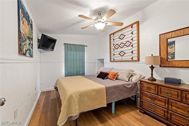 bedroom featuring ceiling fan and hardwood / wood-style flooring