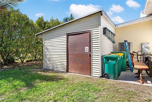 view of outbuilding with a lawn