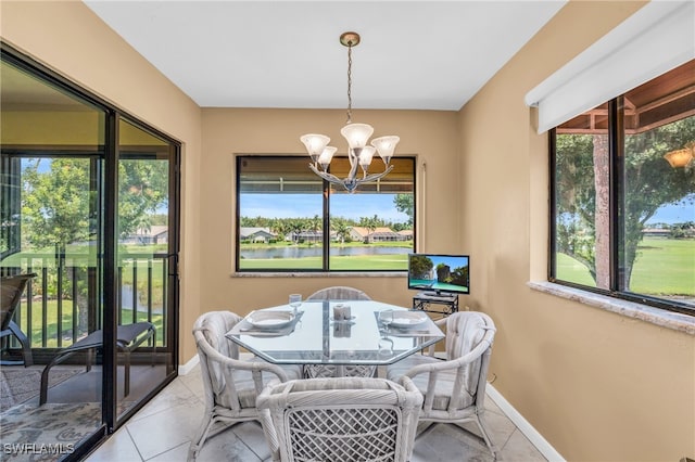 dining space featuring a wealth of natural light, a notable chandelier, and light tile patterned floors