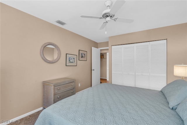 carpeted bedroom featuring a closet and ceiling fan