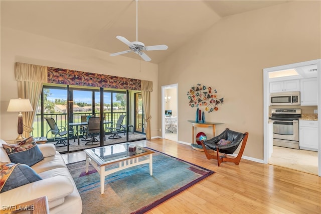 living room featuring high vaulted ceiling, ceiling fan, and light wood-type flooring