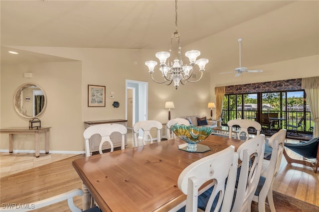 dining area featuring light hardwood / wood-style floors, ceiling fan with notable chandelier, and lofted ceiling