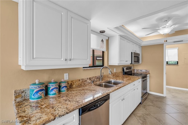 kitchen with sink, ceiling fan, white cabinetry, a raised ceiling, and stainless steel appliances