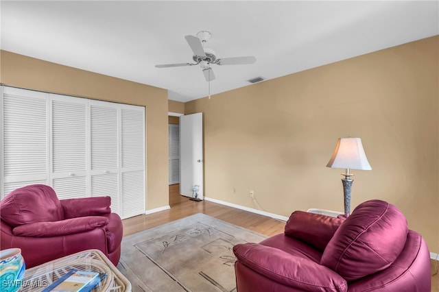 living room featuring ceiling fan and light wood-type flooring