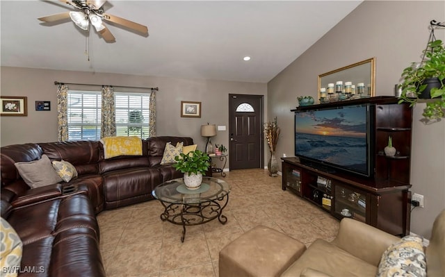 living room with ceiling fan, light tile patterned flooring, and vaulted ceiling