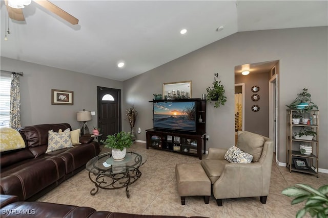 living room with ceiling fan, light tile patterned floors, and vaulted ceiling