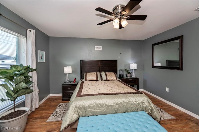 bedroom featuring dark hardwood / wood-style flooring and ceiling fan