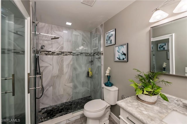 bathroom featuring vanity, toilet, and an enclosed shower