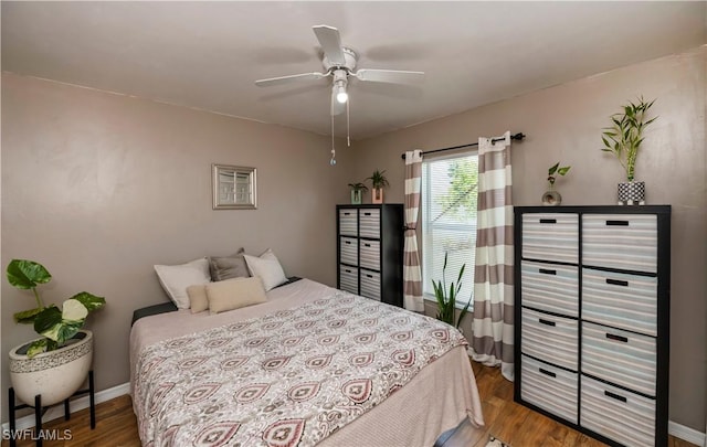 bedroom with ceiling fan and wood-type flooring