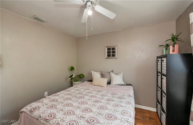 bedroom with ceiling fan and wood-type flooring