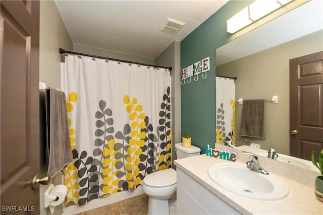 bathroom featuring tile patterned floors, vanity, and toilet