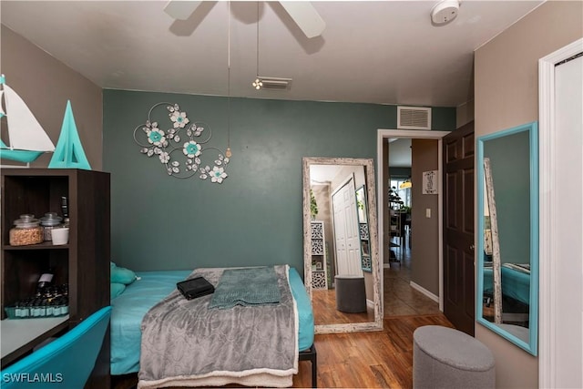 bedroom with wood-type flooring and ceiling fan