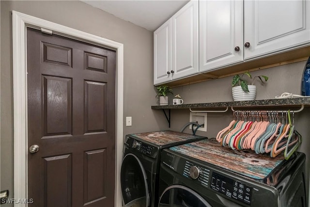 washroom featuring washing machine and dryer and cabinets