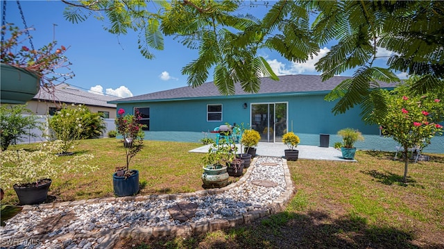 rear view of property with a yard