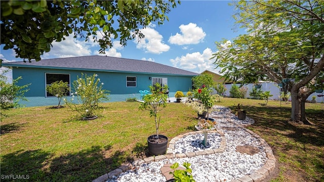 back of house with a lawn