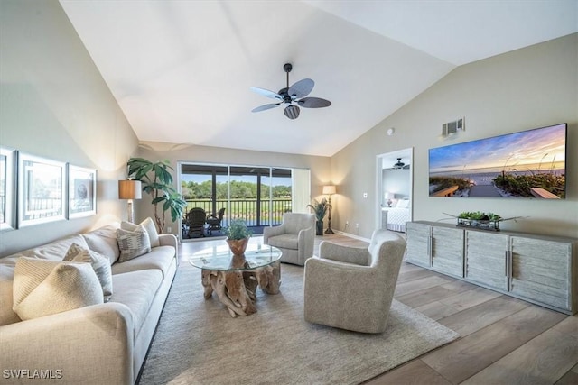 living room featuring hardwood / wood-style floors, ceiling fan, and high vaulted ceiling