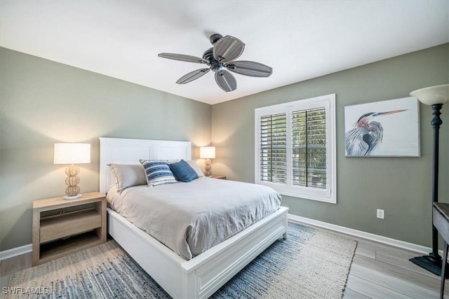 bedroom featuring wood-type flooring and ceiling fan