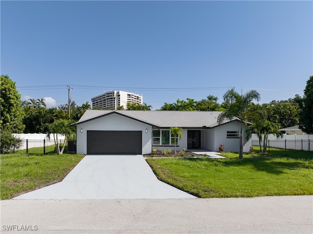 view of front of property featuring a garage and a front lawn